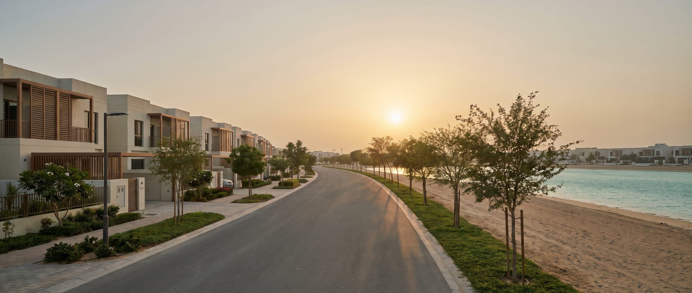 Family villa street at golden hour with a lagoon edge on one side and a golf green on the other