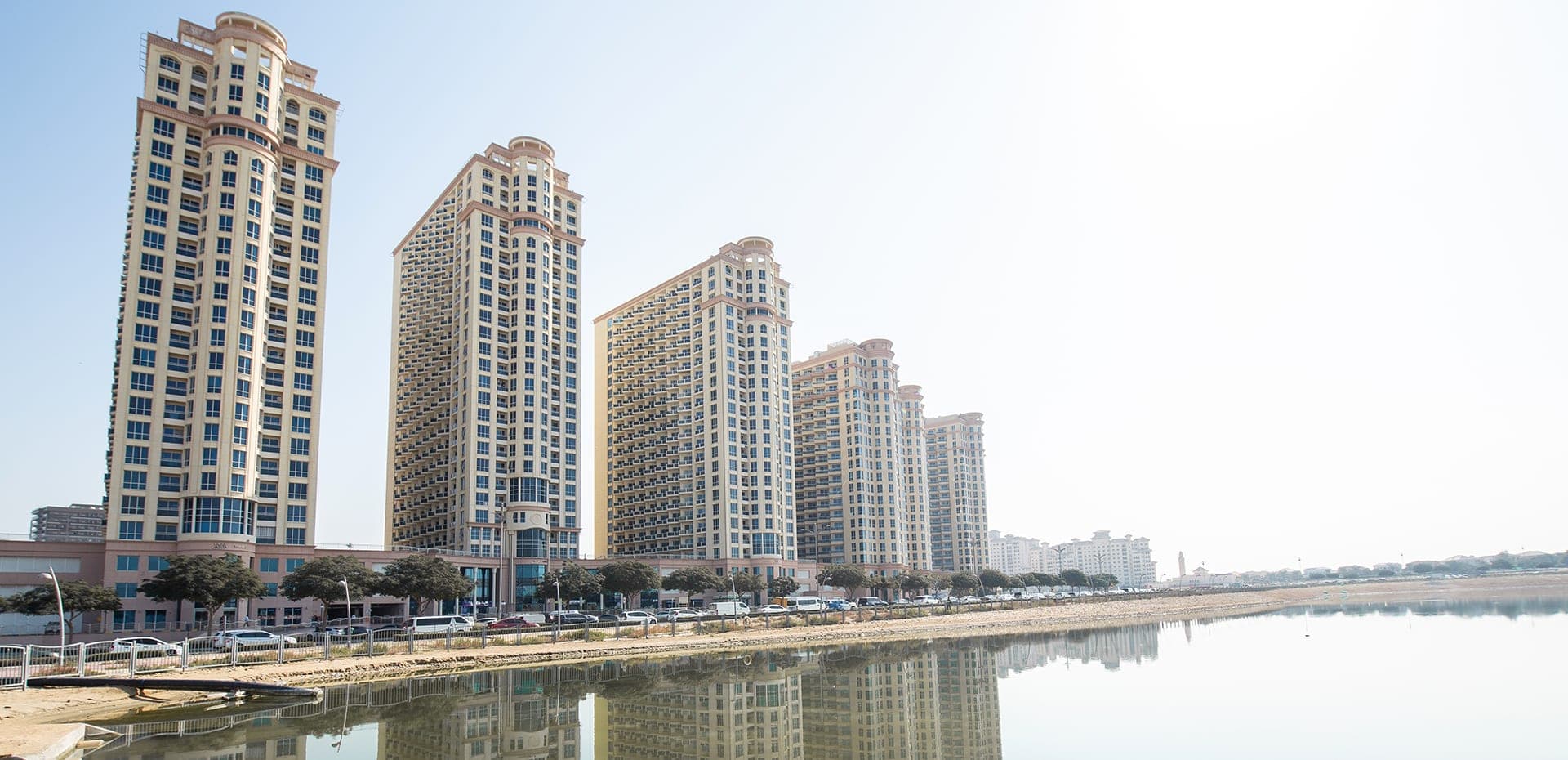 Dubai Production City — TECOM free zone with an apartment district, a community mall and a half-finished lake park