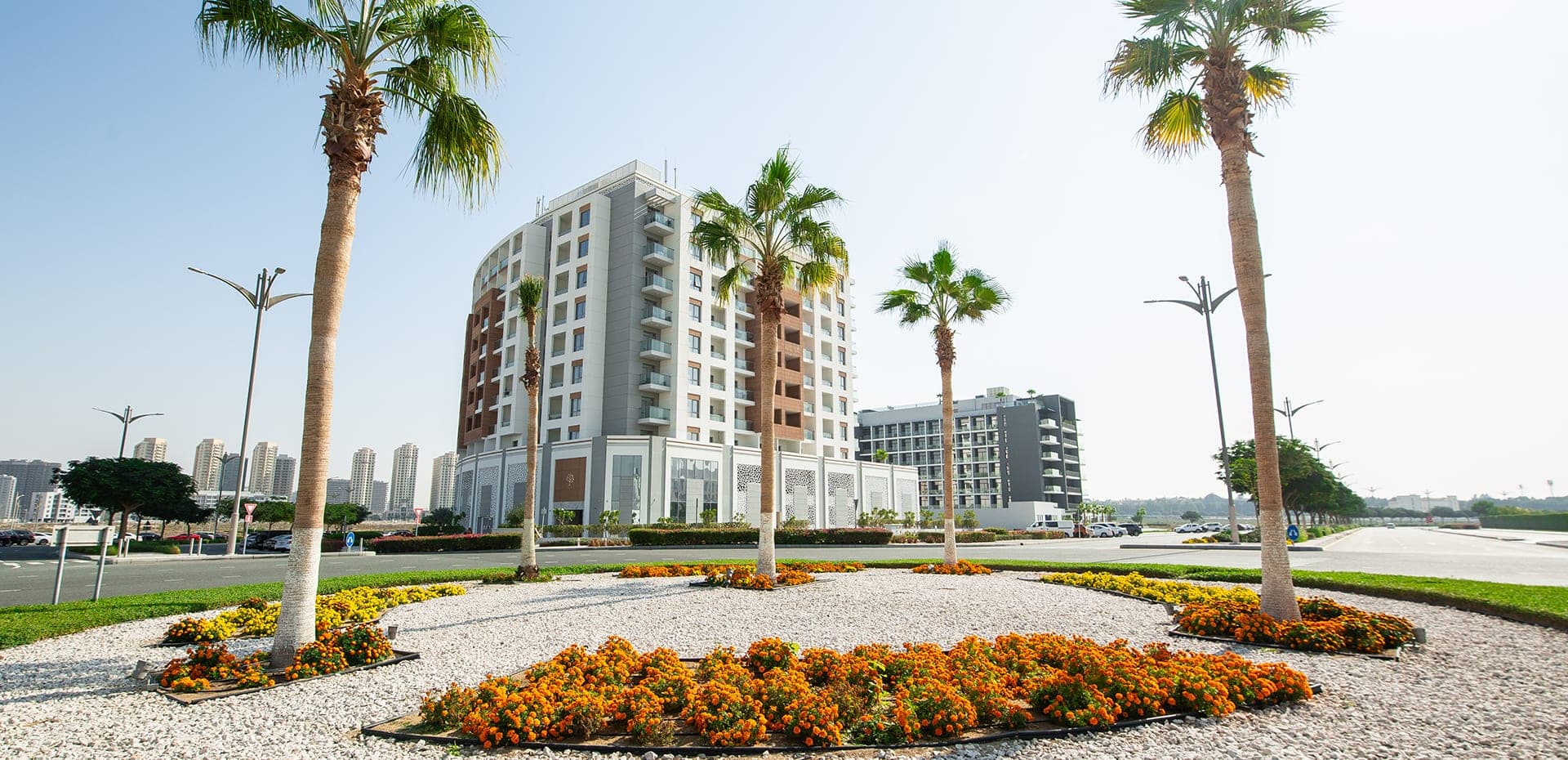 Dubai Production City — TECOM free zone with an apartment district, a community mall and a half-finished lake park