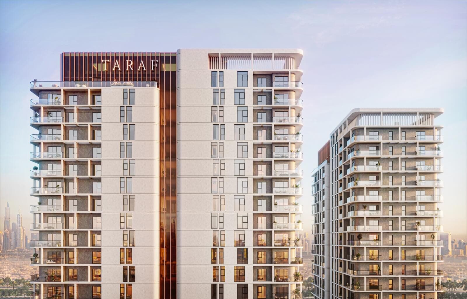 Render of the Cello towers in Jumeirah Village Circle in morning light, white balconied facades beside a copper-toned band carrying the Taraf name