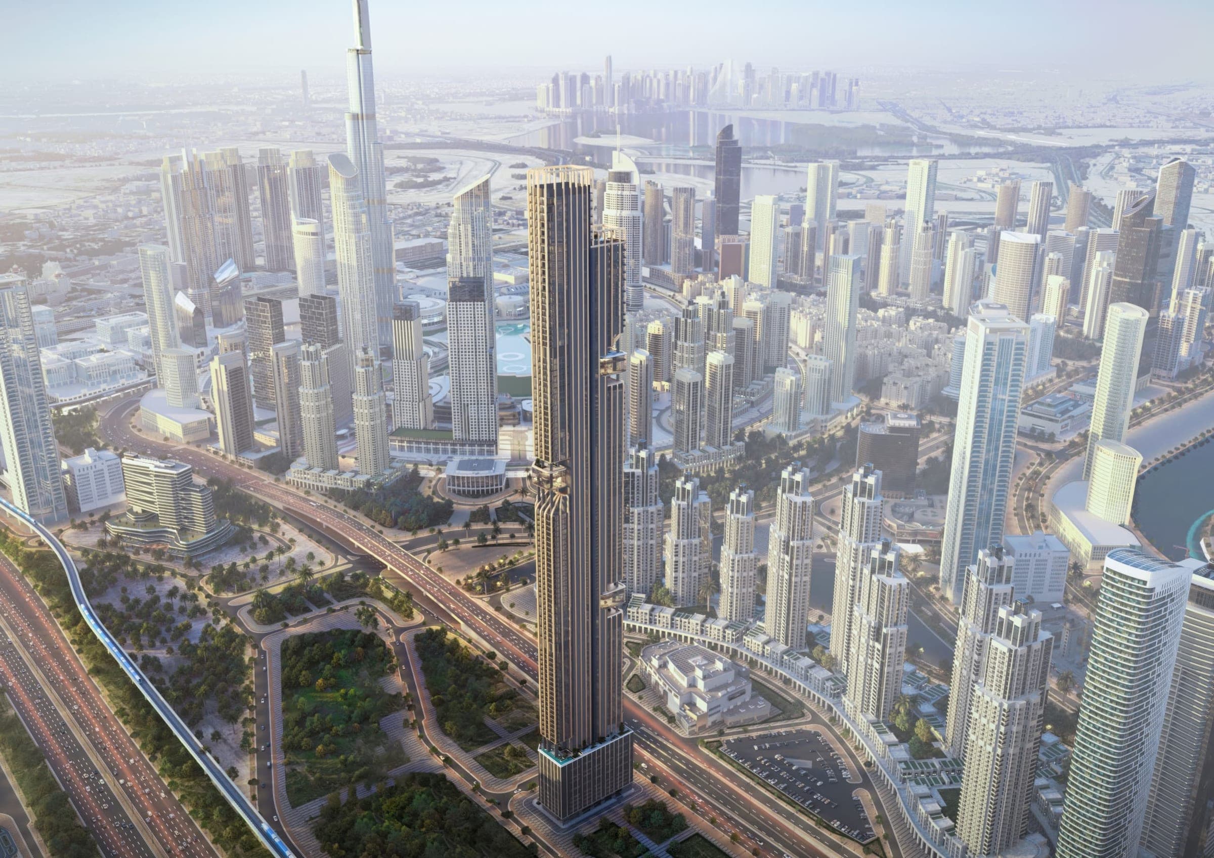 Render of DWTN Residences from the air, a slender dark tower beside a highway and metro line with the Downtown Dubai towers behind