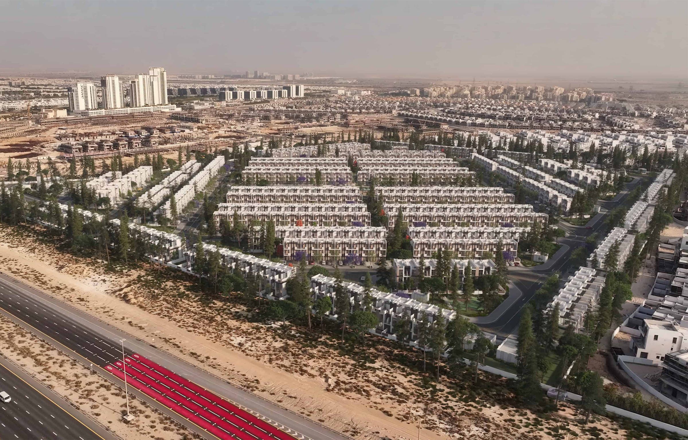 Render of R. Hills from the air, the townhouse rows and landscaping laid out beside the road in Dubailand