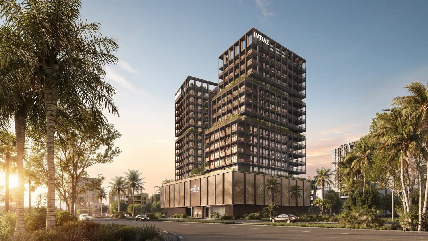 Render of The Archive by Imtiaz in DubaiLand Residence Complex, seen from the road at sunset with The Archive and Imtiaz signage on the building